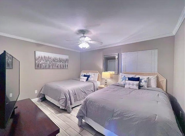 bedroom with ornamental molding and ceiling fan