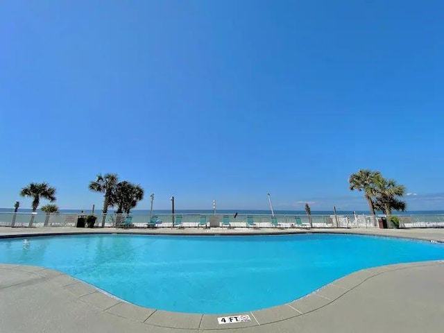 view of pool with a water view