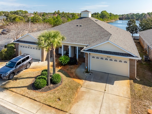 ranch-style house with brick siding, central air condition unit, roof with shingles, a garage, and driveway