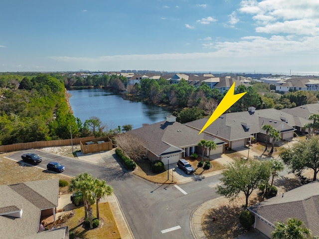 drone / aerial view with a residential view and a water view