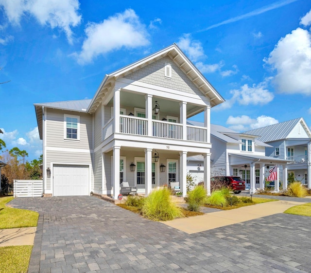 view of front of house featuring a balcony, a garage, and covered porch