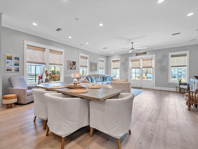 dining area featuring ornamental molding and light hardwood / wood-style floors