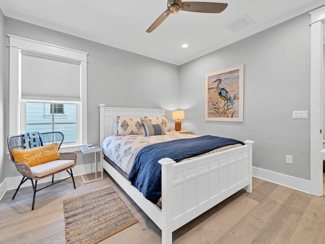 bedroom featuring ceiling fan, ornamental molding, and light hardwood / wood-style flooring