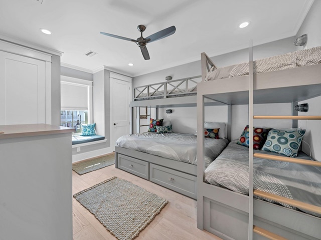 bedroom with ceiling fan, ornamental molding, and light hardwood / wood-style flooring