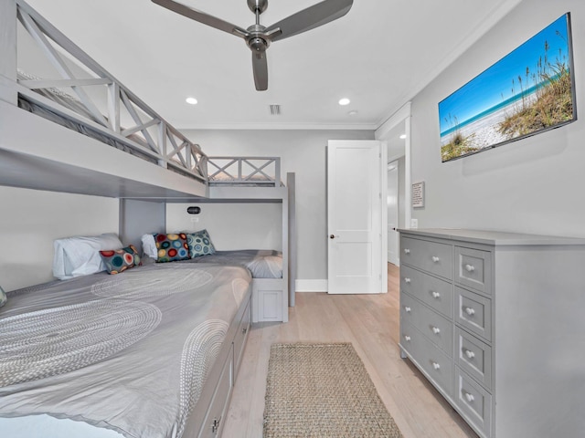 bedroom with ornamental molding, ceiling fan, and light wood-type flooring