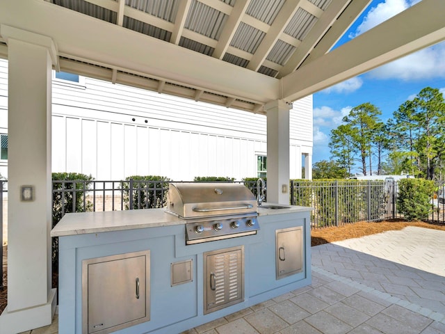 view of patio / terrace featuring sink, grilling area, and an outdoor kitchen