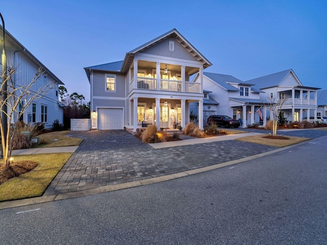 view of front of home featuring a garage and a balcony