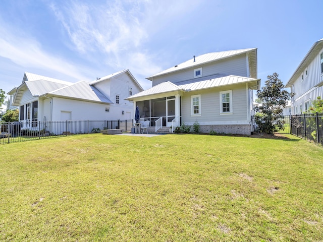 90 White Cottage Rd, Santa Rosa Beach, FL 32459 - back of house with a sunroom, a fenced backyard, a standing seam roof, and a lawn