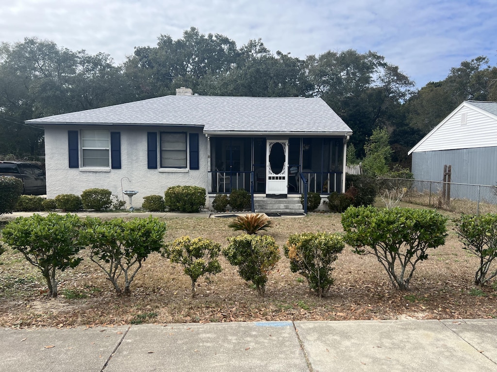 view of front of house featuring a sunroom