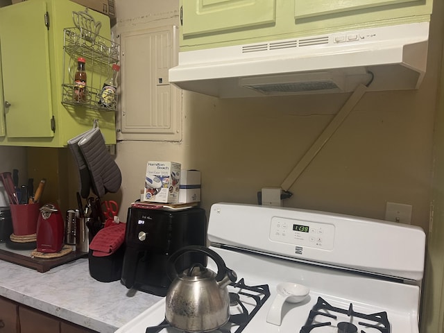118 SE Carson Dr, Fort Walton Beach, FL 32548 - kitchen featuring under cabinet range hood, light countertops, range, and electric panel