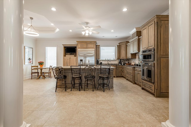 kitchen with stainless steel appliances, a healthy amount of sunlight, a center island, and a breakfast bar area