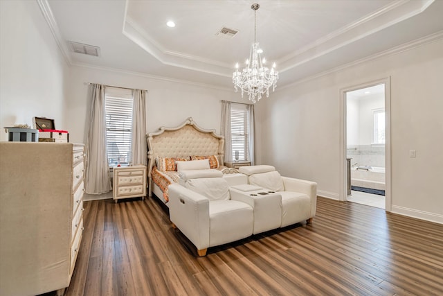 bedroom with connected bathroom, a chandelier, ornamental molding, dark hardwood / wood-style floors, and a raised ceiling