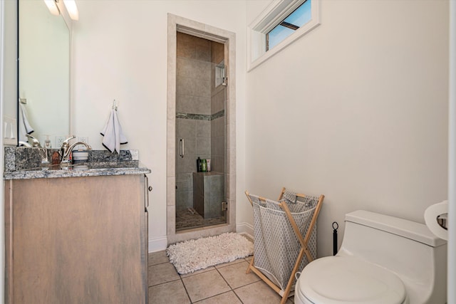 bathroom featuring tile patterned flooring, vanity, an enclosed shower, and toilet