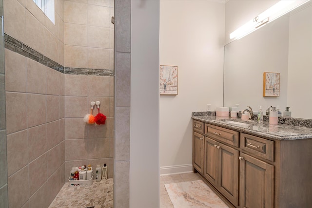 bathroom featuring vanity and tiled shower