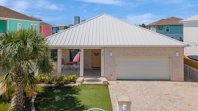 view of front of property featuring a garage, a front yard, and covered porch