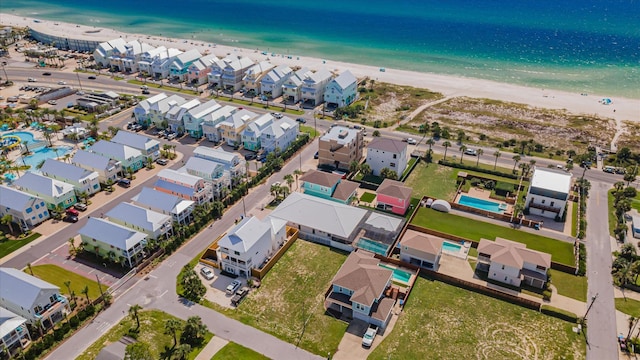 drone / aerial view featuring a water view and a beach view