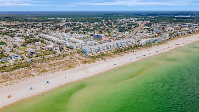 birds eye view of property with a water view and a beach view