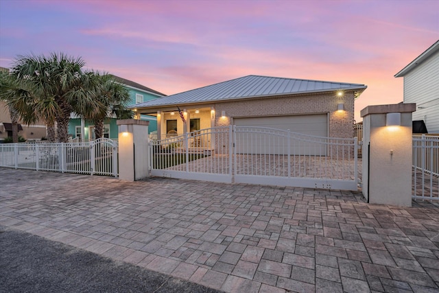 gate at dusk with a garage