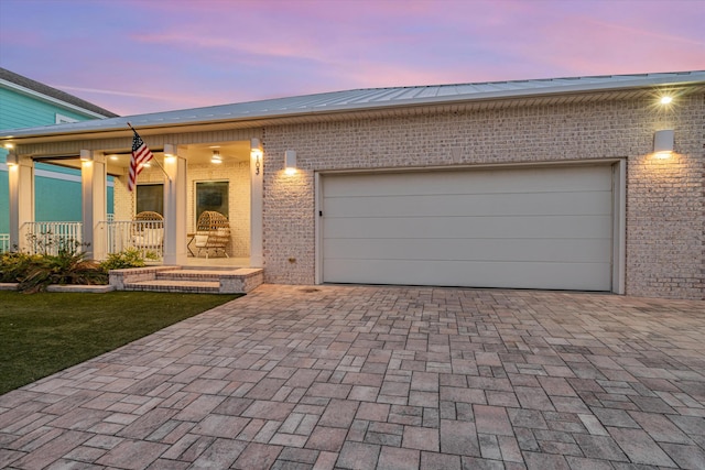 view of front of home featuring a porch and a garage