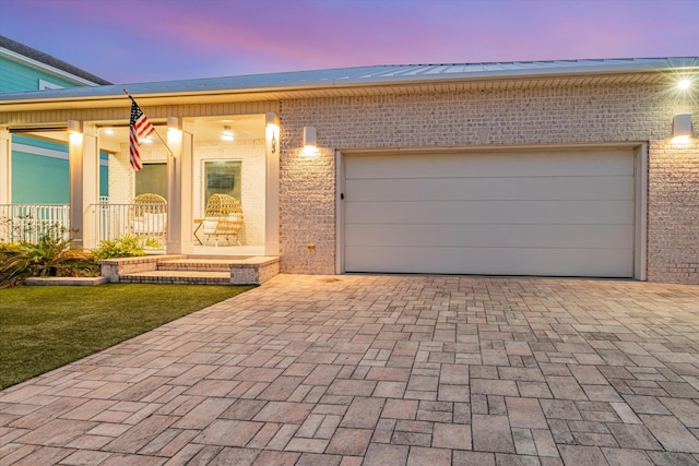 view of front facade featuring a garage and a porch