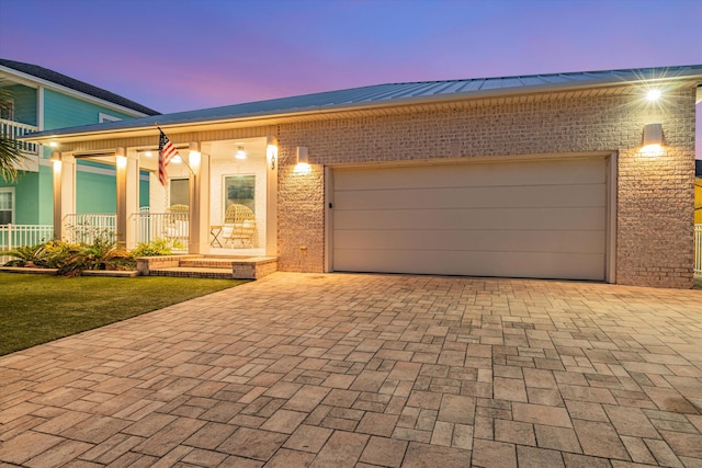 view of front of property featuring a garage and covered porch