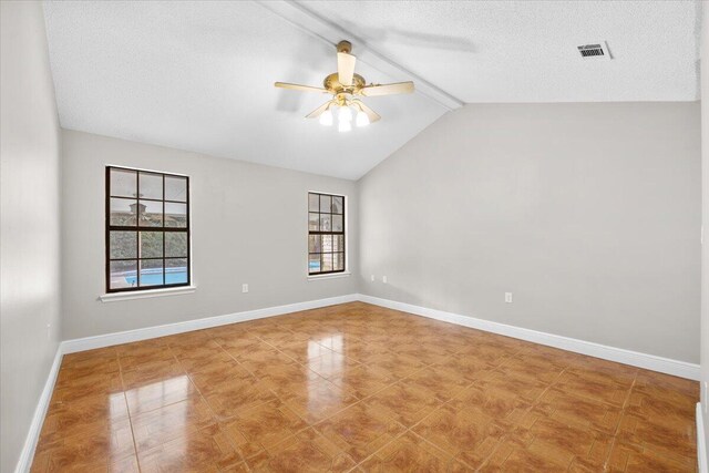 2185 Calle De Castelar, Navarre, FL 32566 - spare room with vaulted ceiling with beams, ceiling fan, a textured ceiling, and a wealth of natural light