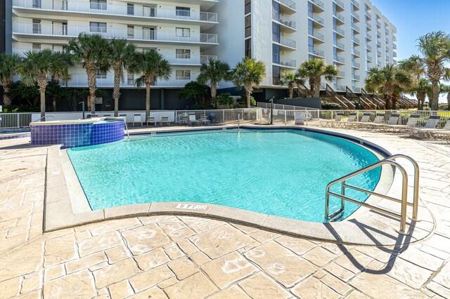 view of swimming pool with pool water feature