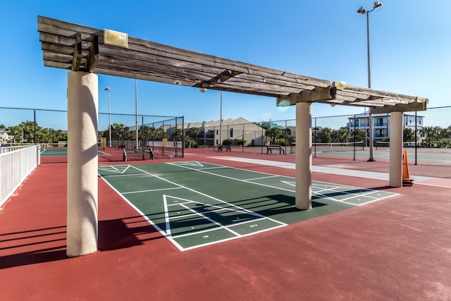 view of property's community featuring tennis court