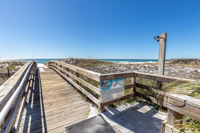 view of community featuring a beach view and a water view