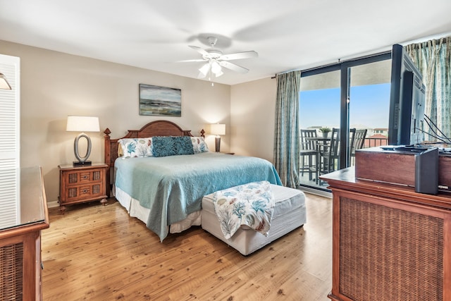 bedroom featuring expansive windows, ceiling fan, light hardwood / wood-style floors, and access to outside