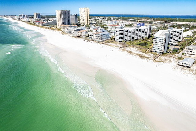 birds eye view of property featuring a water view and a beach view