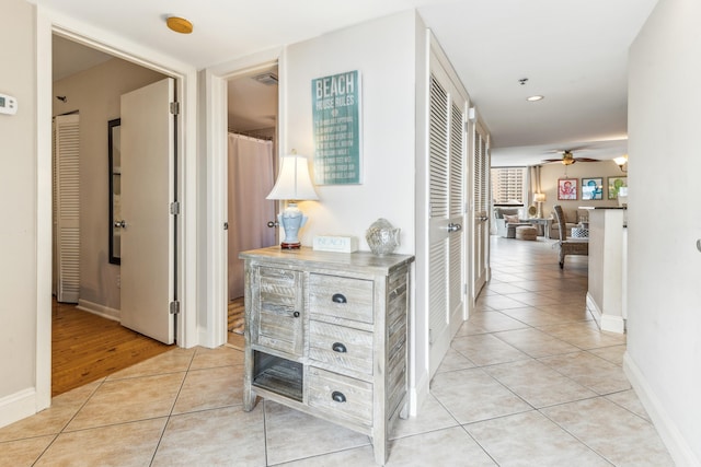 hall featuring light tile patterned floors