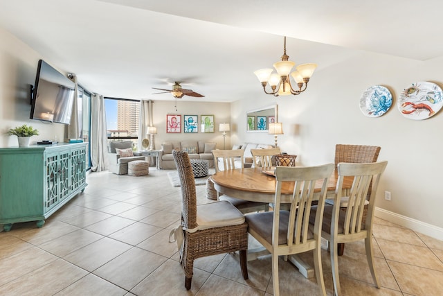 dining space with ceiling fan with notable chandelier and light tile patterned floors