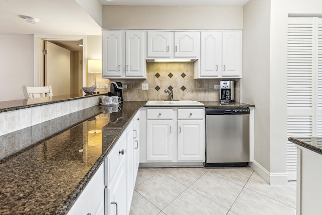 kitchen with white cabinetry, sink, dark stone countertops, and dishwasher