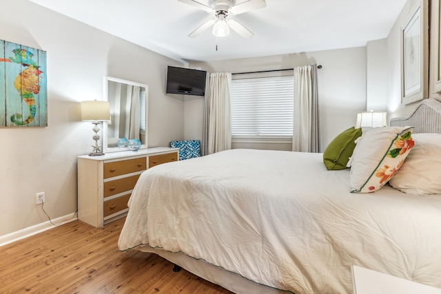 bedroom with light hardwood / wood-style flooring and ceiling fan