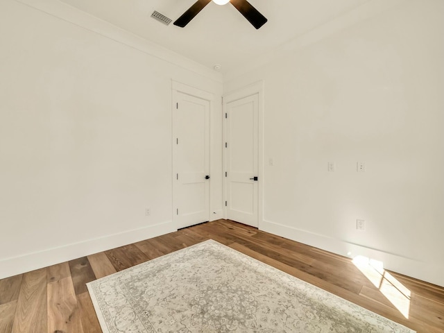 empty room featuring hardwood / wood-style floors and ceiling fan