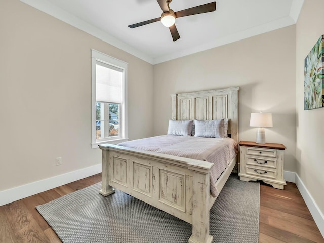 bedroom with crown molding, ceiling fan, and hardwood / wood-style floors