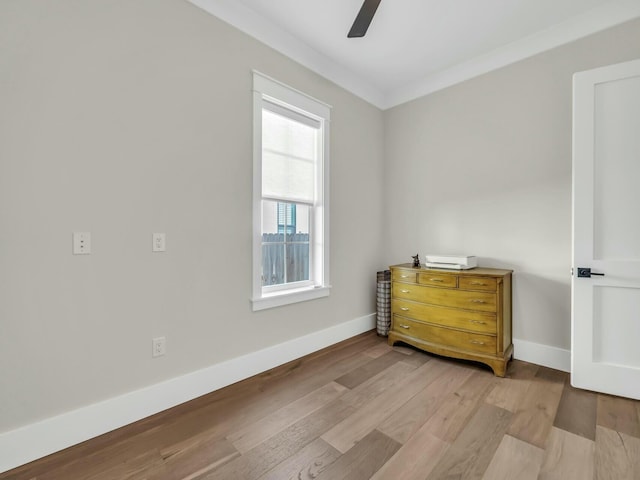 bedroom featuring ornamental molding, ceiling fan, and light hardwood / wood-style flooring