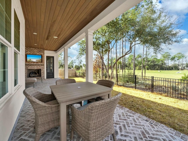 view of patio / terrace featuring an outdoor brick fireplace