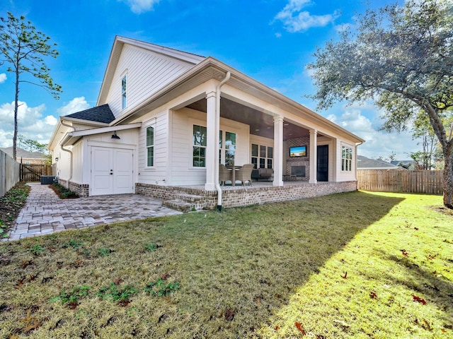 back of house featuring a yard and a patio area