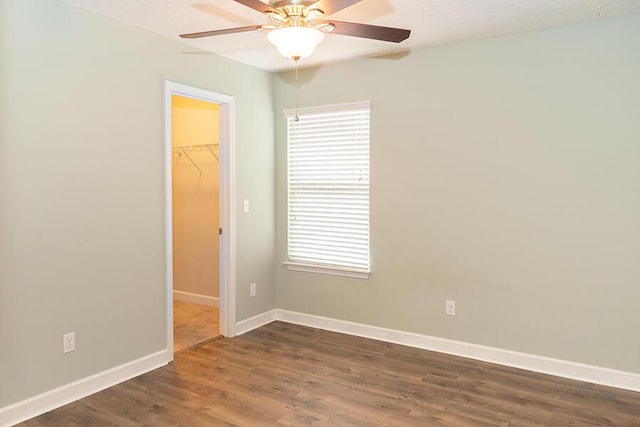 spare room featuring ceiling fan and dark hardwood / wood-style floors