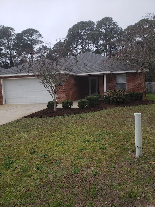 single story home featuring a garage and a front yard