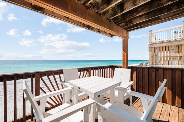 deck with a view of the beach and a water view