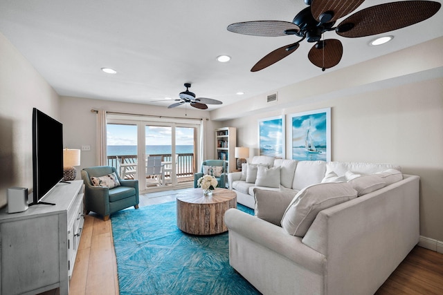 living area with light wood-style flooring, recessed lighting, and visible vents