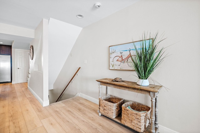 stairs with baseboards and wood finished floors