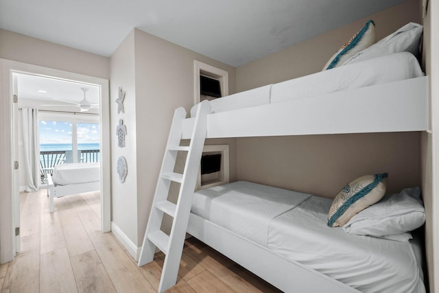 bedroom featuring access to outside, light wood-style floors, and baseboards