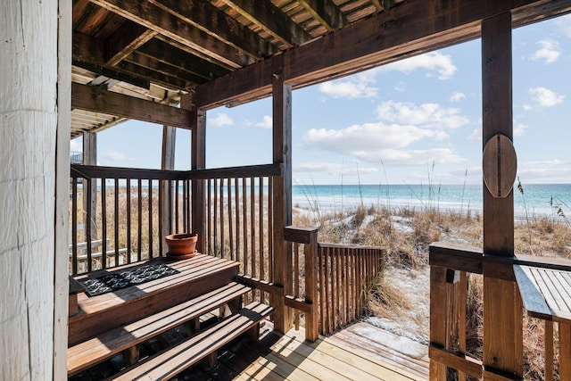 deck featuring a water view and a beach view