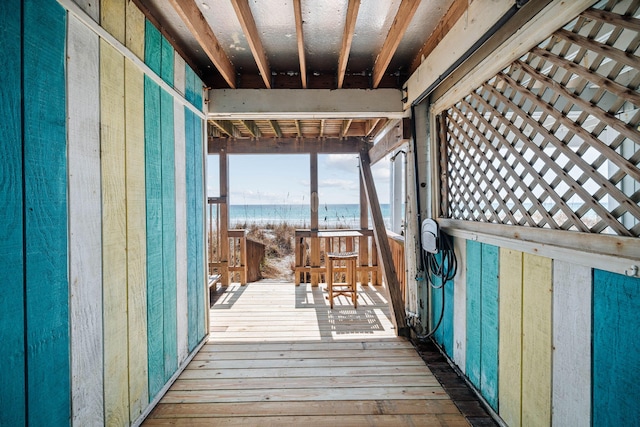 wooden terrace featuring a water view