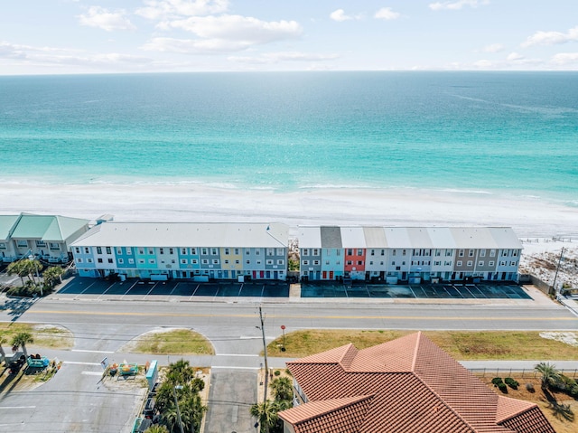 birds eye view of property featuring a water view and a beach view