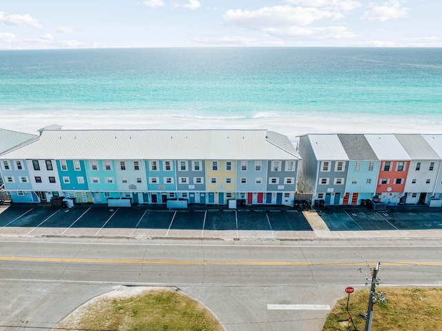 birds eye view of property featuring a beach view and a water view